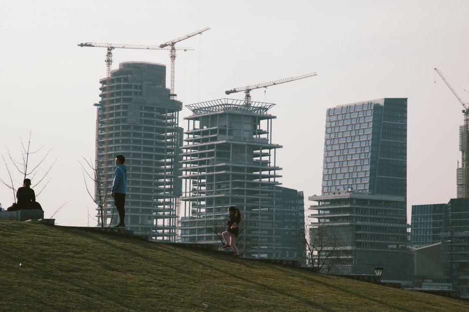 People Looking at Skyscrapers Construction Site
